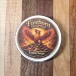 Before and after comparison of Emberforge finish applied to a wood board showing the intense red-copper ember warmth.